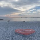 marble beach at sunset, white pebbles and ocean scenery