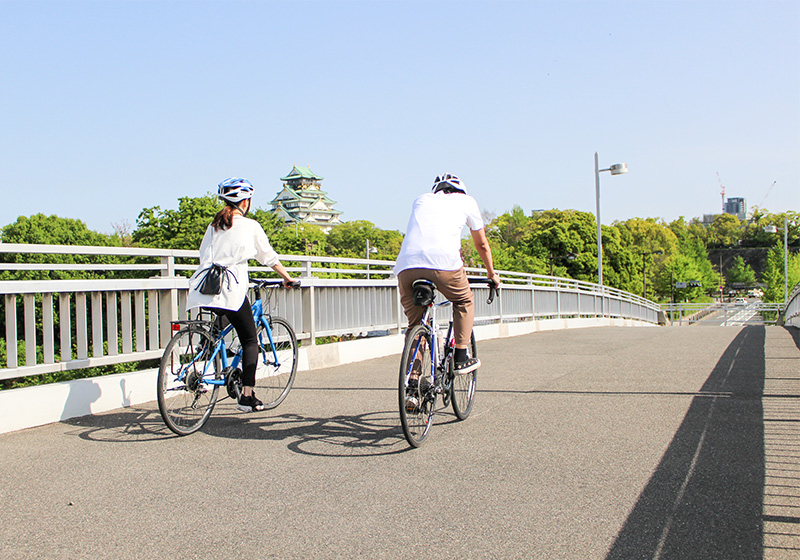 view of Osaka Castle on rental bikes