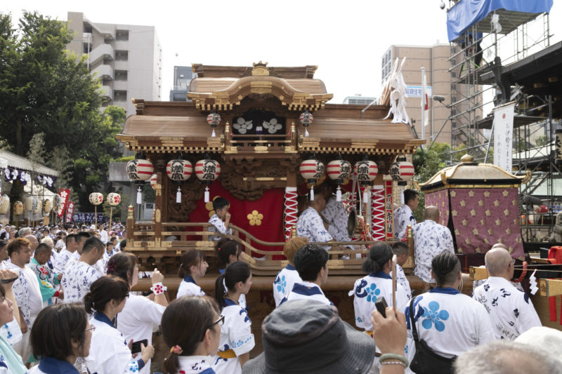 ornately carved festival float is pulled out of Osaka Tenmangu Shrine for festival procession