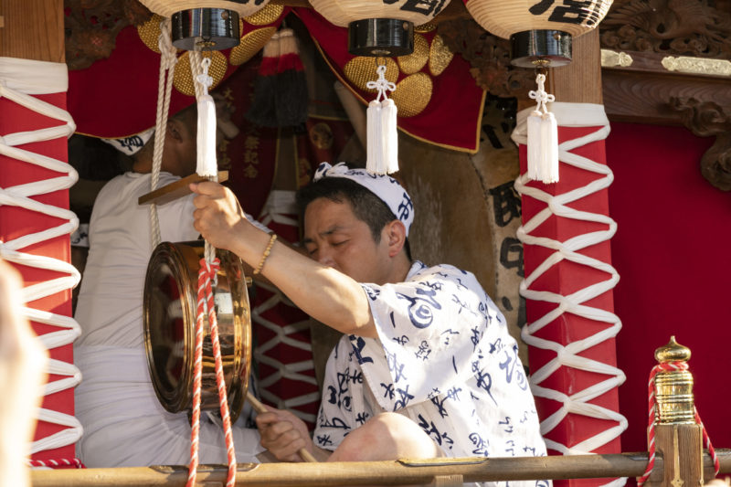 musician plays drums and gong at Tenjin Festival in Osaka