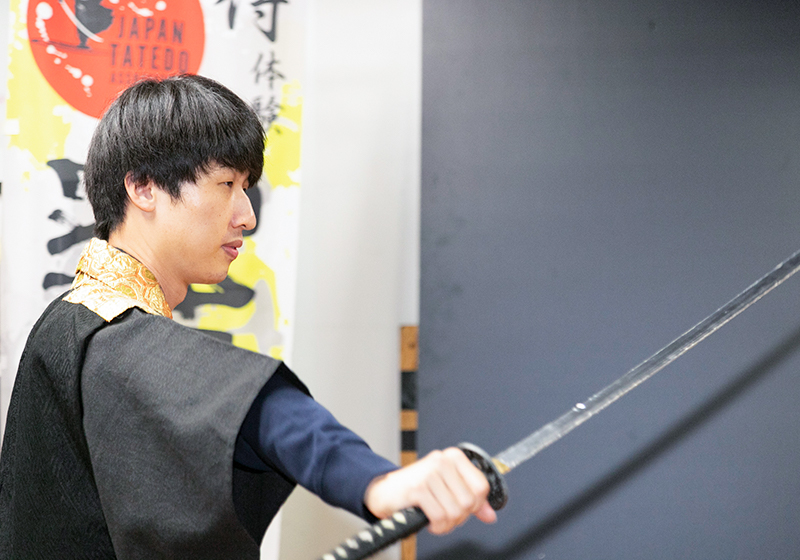 drawing a sword during samurai experience at the Japan Sword Fighting Association in Osaka
