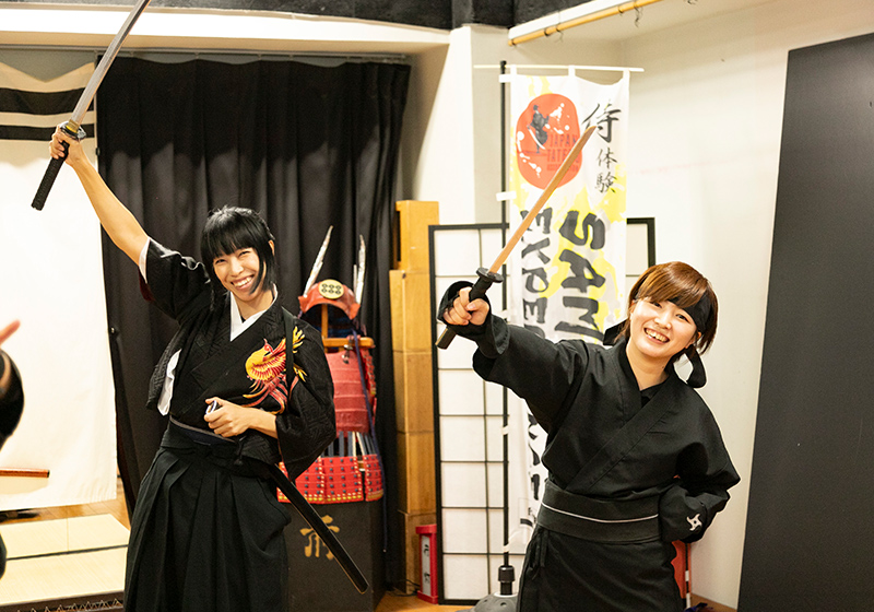 two woman ninjas with swords drawn at the Japan Tatedo Association in Osaka