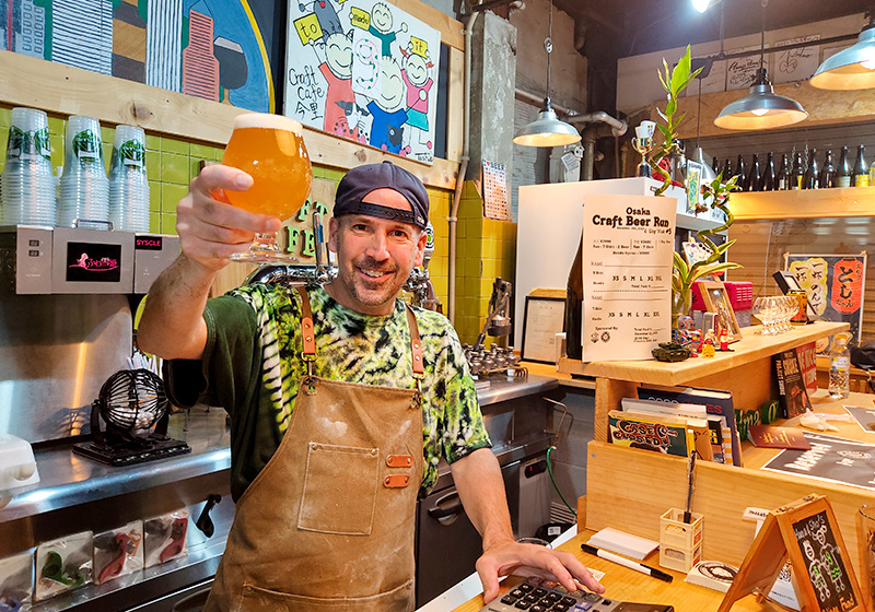 owner of Imazato craft cafe welcomes guests into his pub with a smile and great beer