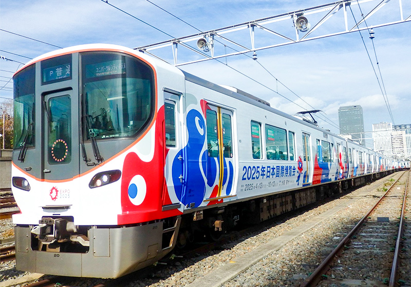Red, white & blue Osaka Expo design wrapped JR train