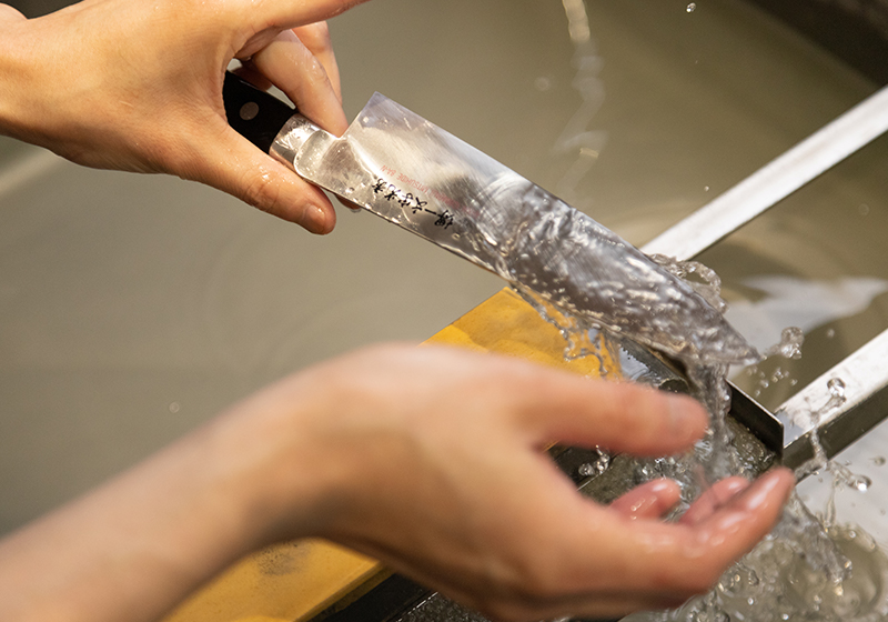 Japanese knife being professionally sharpened at Sakai Ichimonji Mitsuhide