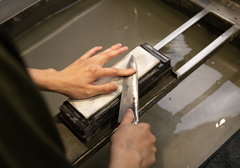 Japanese knife being professionally sharpened at Sakai Ichimonji Mitsuhide